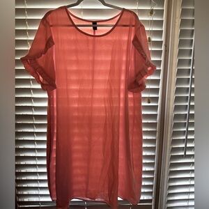 Peach colored sheath dress with detailed sleeves.